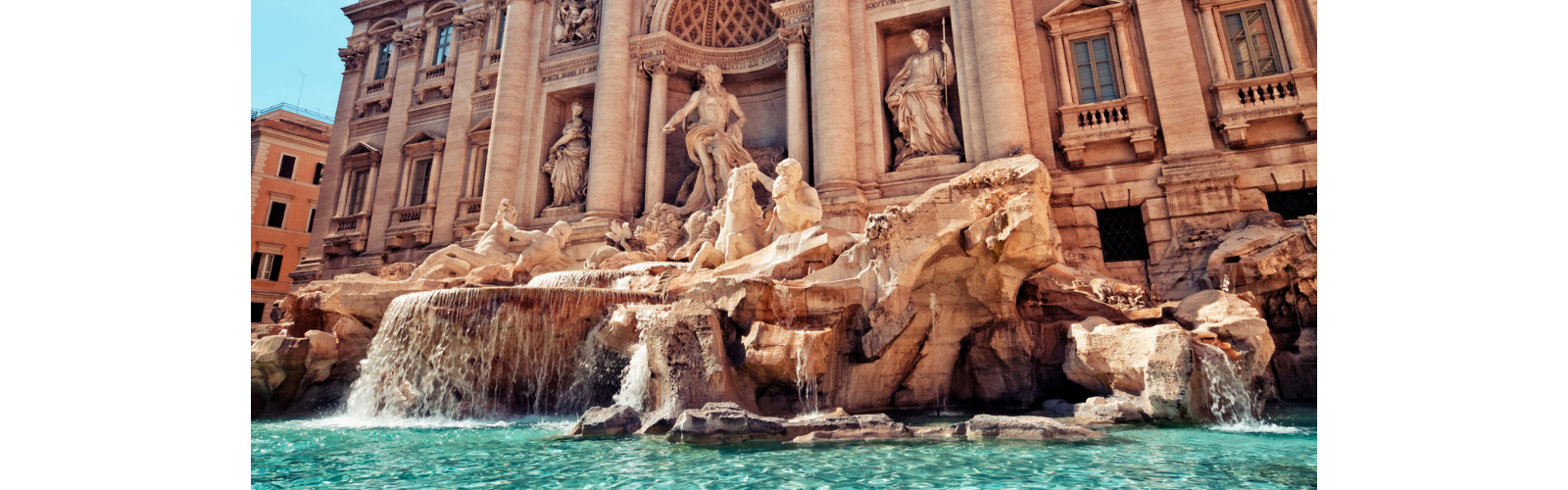 A stone fountain in front of tall building with pillars. The fountain contains many sculptures of robed figures in various poses.